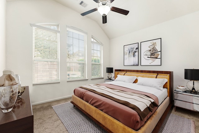 bedroom with ceiling fan, vaulted ceiling, and light carpet