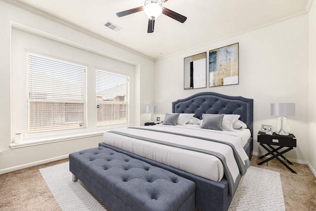 bedroom featuring crown molding, ceiling fan, and light carpet