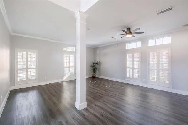 empty room featuring ornamental molding, a healthy amount of sunlight, and ornate columns