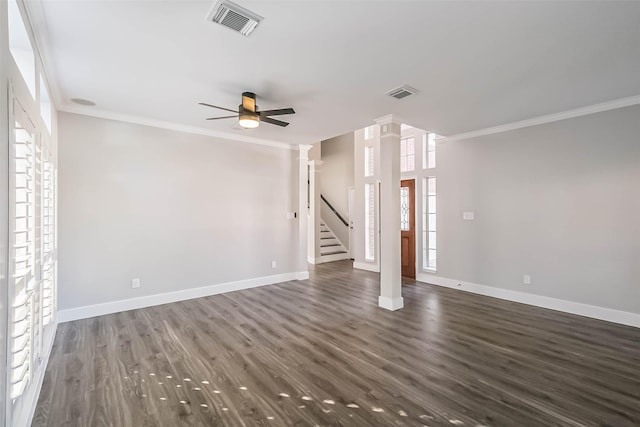 unfurnished living room with decorative columns, ornamental molding, dark hardwood / wood-style floors, and ceiling fan