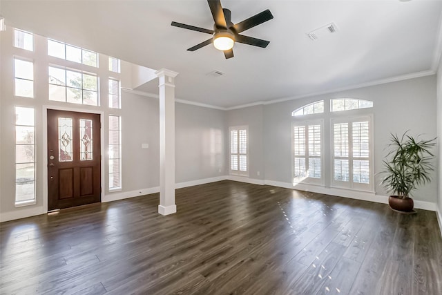 foyer entrance featuring ornate columns, ornamental molding, ceiling fan, and dark hardwood / wood-style flooring