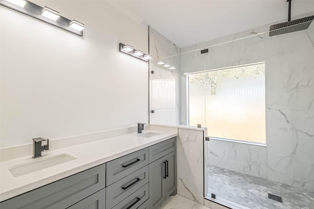 bathroom with vanity and a tile shower