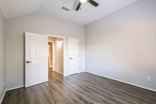 unfurnished bedroom with vaulted ceiling, dark hardwood / wood-style floors, and ceiling fan