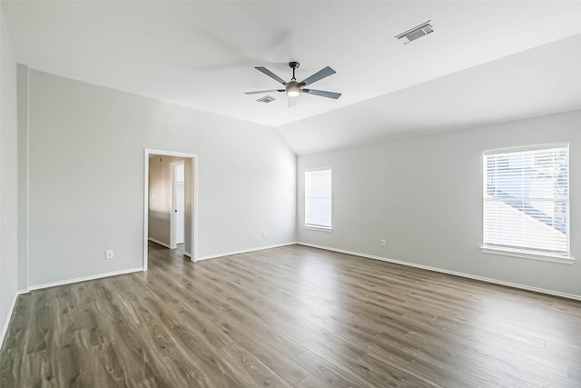 empty room featuring ceiling fan, lofted ceiling, and dark hardwood / wood-style floors