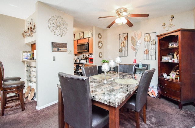 dining area with dark colored carpet and ceiling fan