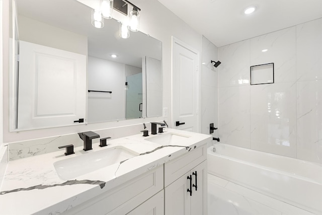 bathroom with vanity and tiled shower / bath combo