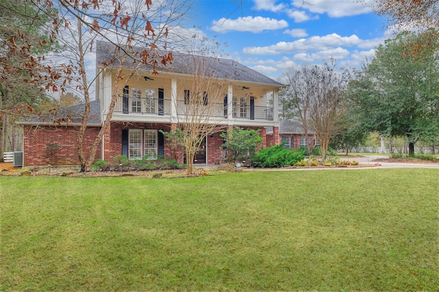 view of front of home featuring a balcony, a front yard, ceiling fan, and cooling unit