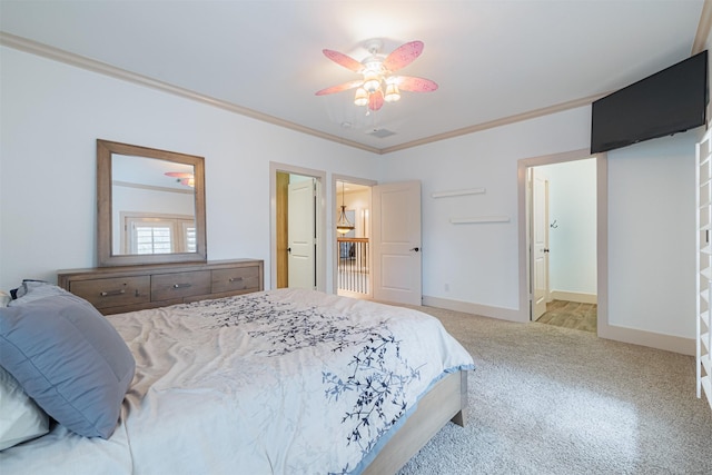 carpeted bedroom featuring ornamental molding and ceiling fan