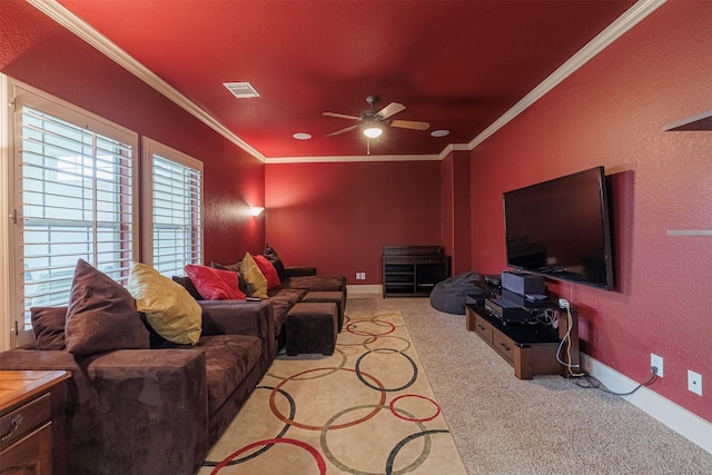 carpeted living room with ornamental molding and ceiling fan