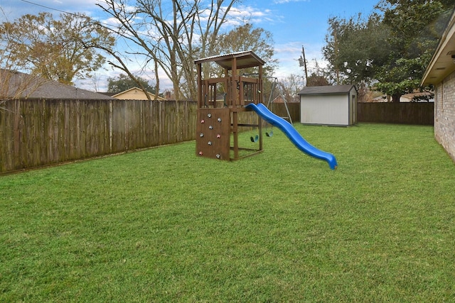 view of jungle gym featuring a lawn and a storage unit