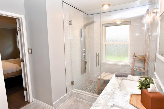 bathroom featuring vanity, wood-type flooring, and walk in shower