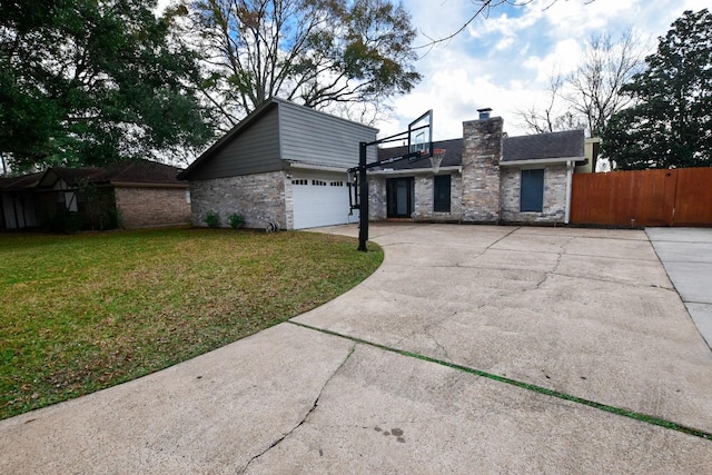 view of front facade with a garage and a front lawn