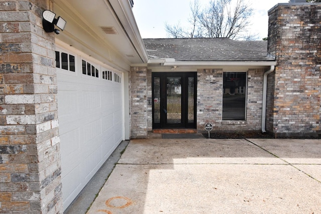 view of exterior entry with a garage