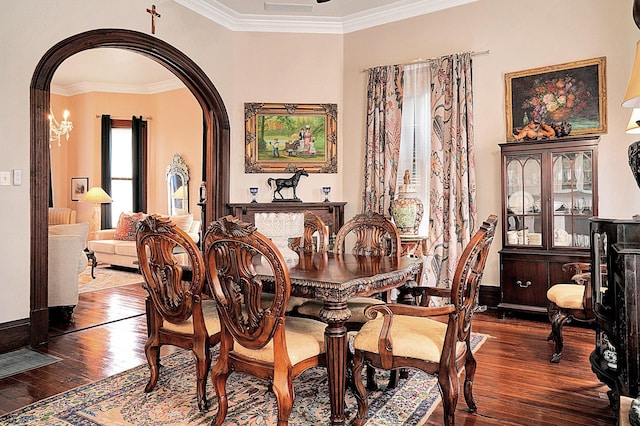 dining area featuring ornamental molding and dark hardwood / wood-style floors