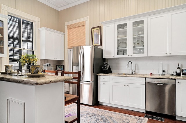 kitchen featuring sink, appliances with stainless steel finishes, backsplash, light stone counters, and white cabinets