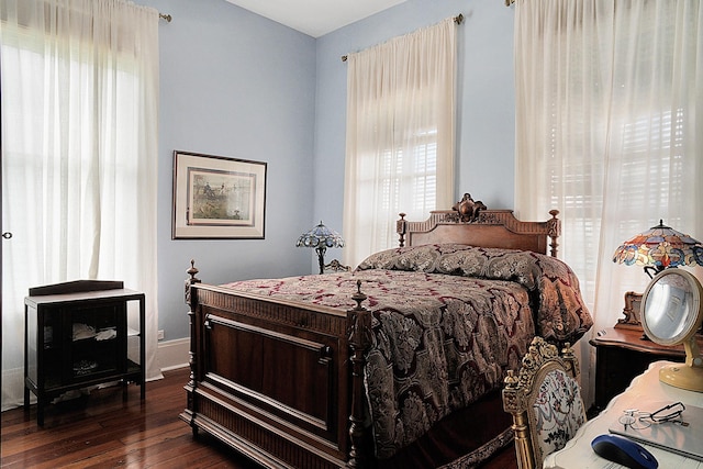 bedroom with dark hardwood / wood-style flooring