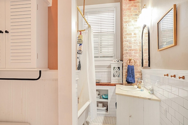 bathroom featuring vanity, tile walls, tile patterned floors, and walk in shower