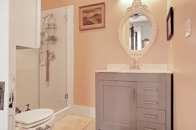 bathroom featuring vanity, a shower with shower door, and toilet