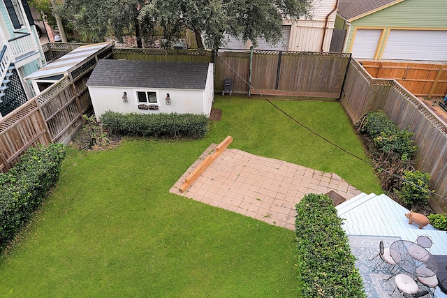 view of yard featuring a patio area and a shed