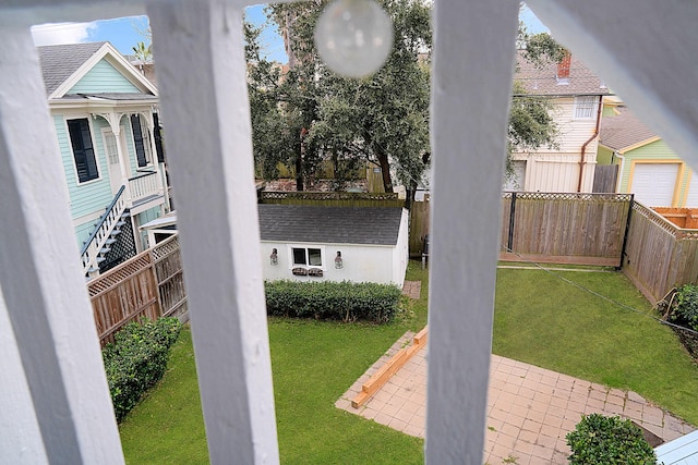 view of yard with a shed and a patio