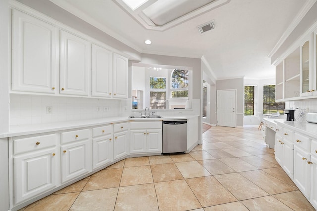 kitchen with sink, backsplash, white cabinets, light tile patterned flooring, and stainless steel dishwasher