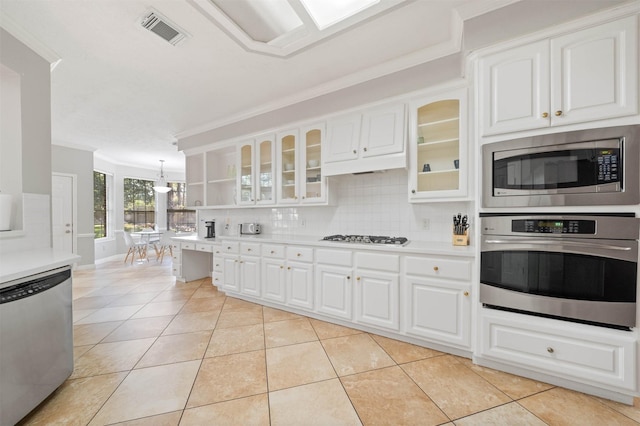 kitchen featuring light tile patterned floors, white cabinets, pendant lighting, stainless steel appliances, and backsplash