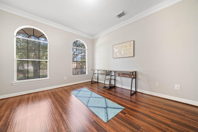 empty room featuring dark wood-type flooring and ornamental molding