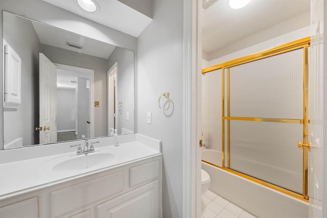 full bathroom with vanity, tile patterned flooring, toilet, and combined bath / shower with glass door