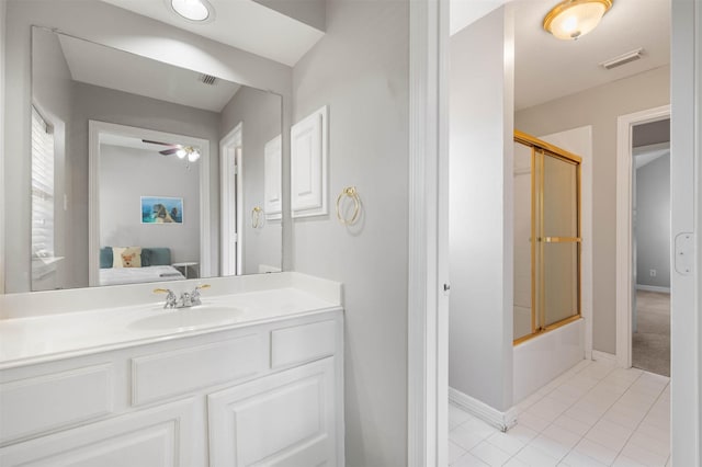 bathroom with tile patterned flooring, vanity, combined bath / shower with glass door, and ceiling fan