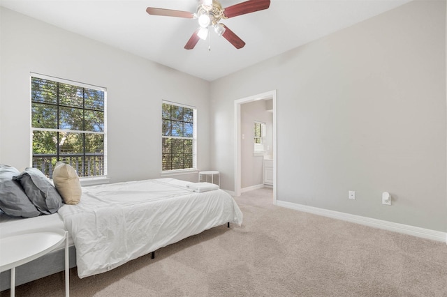 carpeted bedroom featuring connected bathroom and ceiling fan