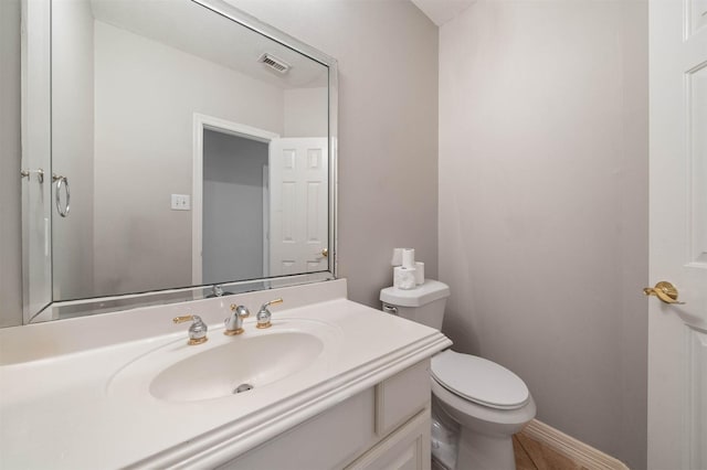 bathroom featuring vanity and toilet