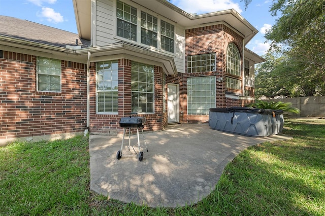 doorway to property with a yard and a patio