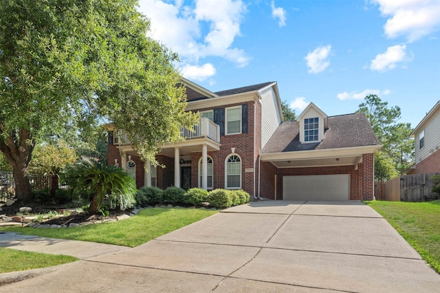 view of front of home featuring a garage, a front lawn, and a balcony