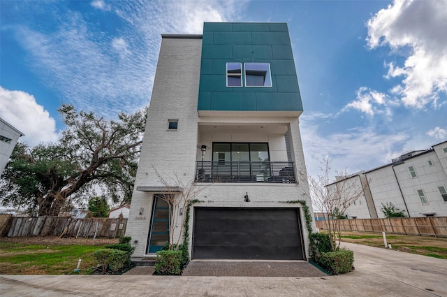 contemporary home with a garage and a balcony