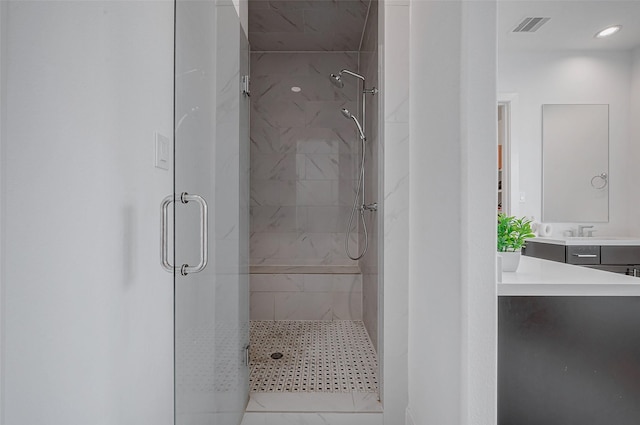 bathroom featuring vanity and a shower with shower door