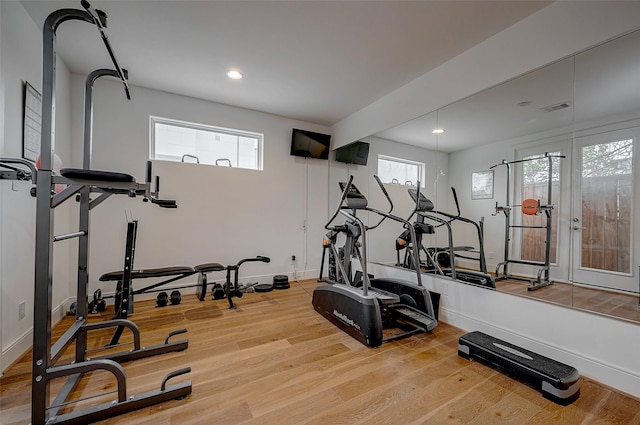 exercise room featuring light wood-type flooring