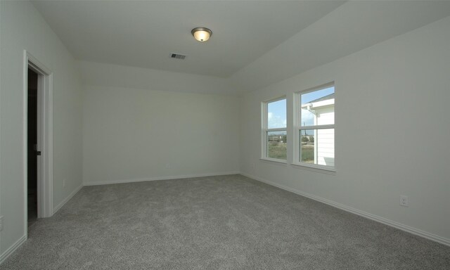 unfurnished room with visible vents, baseboards, and carpet flooring