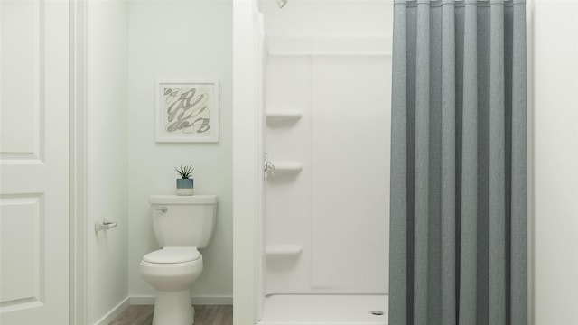 bathroom with walk in shower, wood-type flooring, and toilet