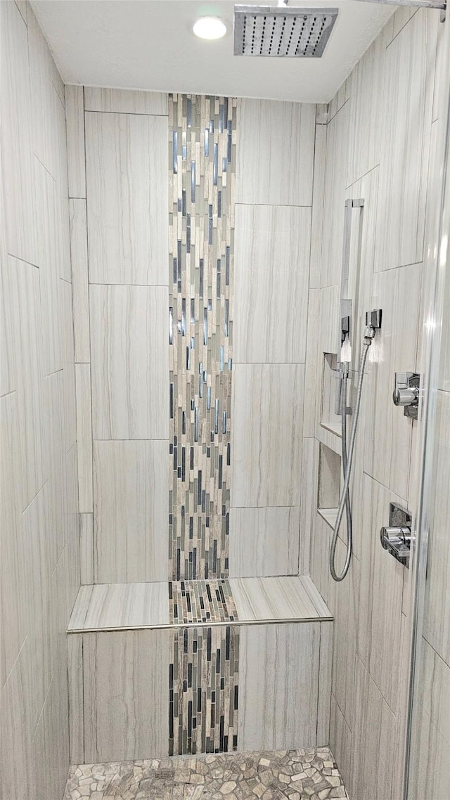 bathroom with a tile shower