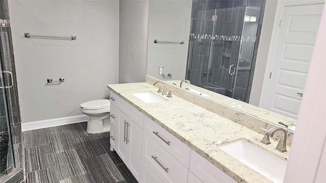 bathroom featuring walk in shower, vanity, and toilet