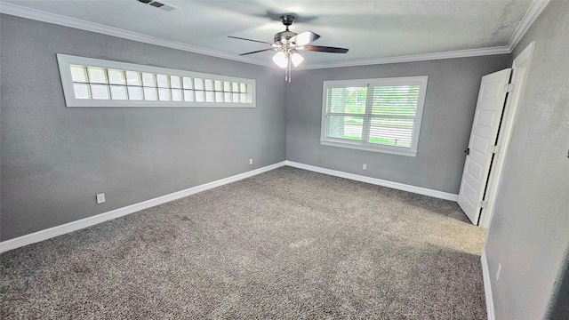 carpeted spare room featuring crown molding and ceiling fan