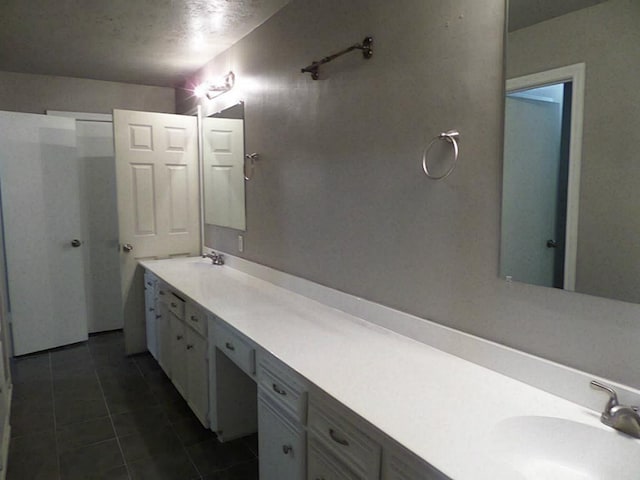 bathroom with vanity and tile patterned floors