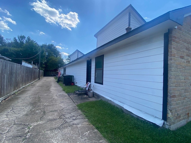 view of property exterior with a patio