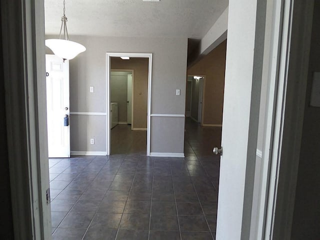 empty room featuring dark tile patterned flooring