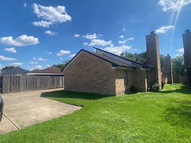 exterior space with a patio and a lawn