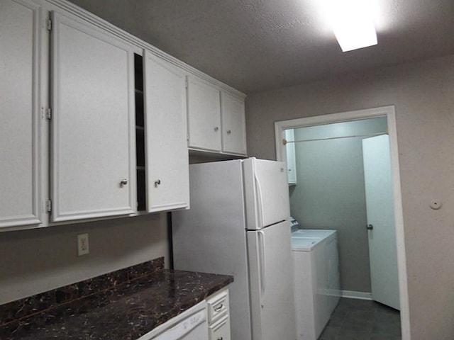 laundry area with washer / clothes dryer and dark tile patterned flooring