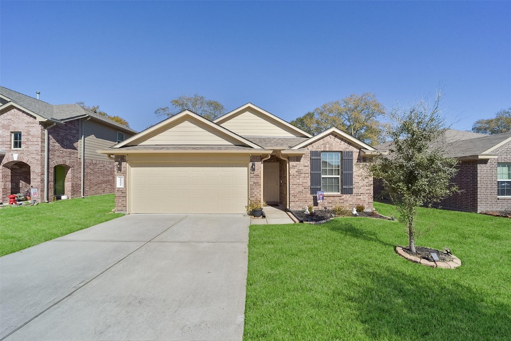 view of front of house with a garage and a front lawn