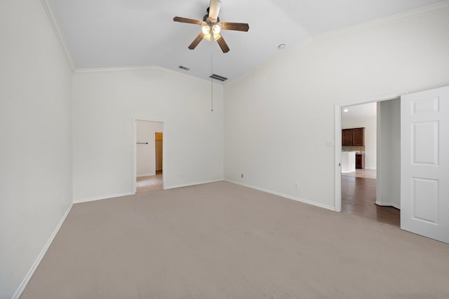 carpeted empty room with lofted ceiling, ornamental molding, and ceiling fan