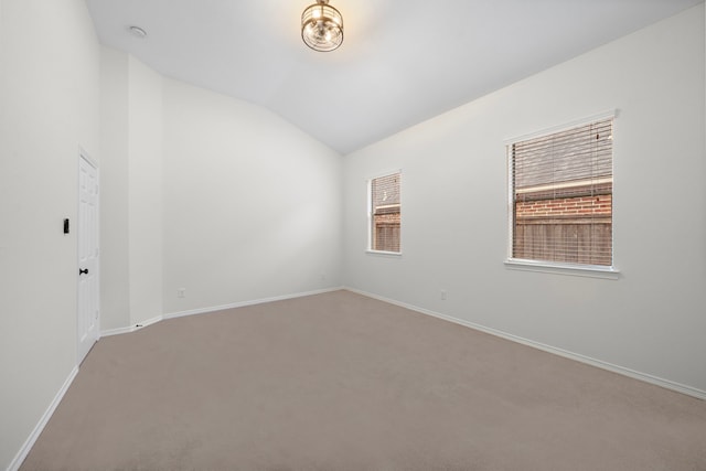 spare room with lofted ceiling and carpet floors