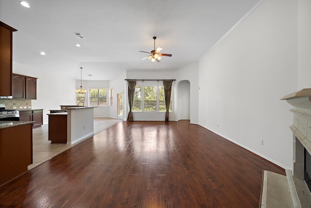 unfurnished living room featuring crown molding, ceiling fan, and light hardwood / wood-style floors